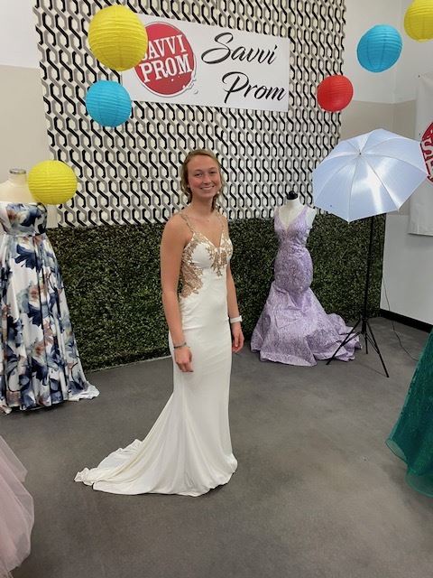 Photo of the model wearing a white prom gown