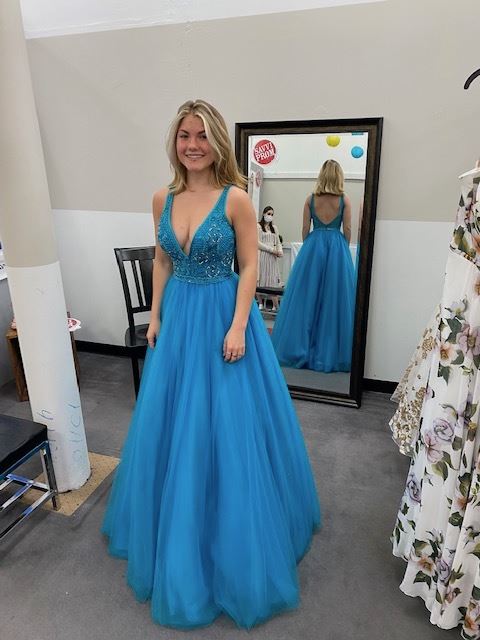 Model wearing a blue prom gown