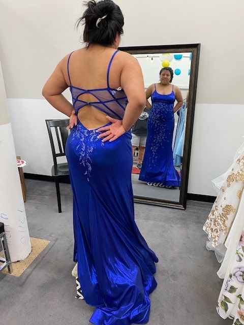 Model wearing a dark blue prom gown