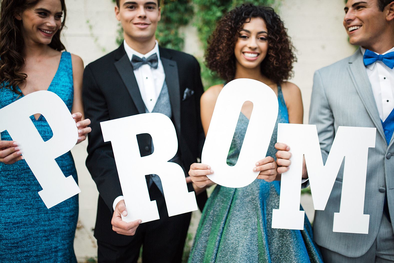 Models holding prom letters